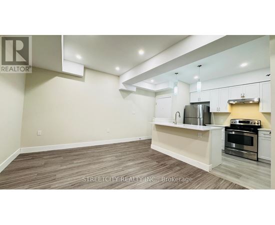 A kitchen with white cabinets and a stainless steel oven.