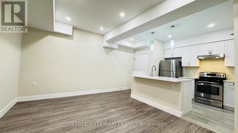 A kitchen with white cabinets and a stainless steel oven.