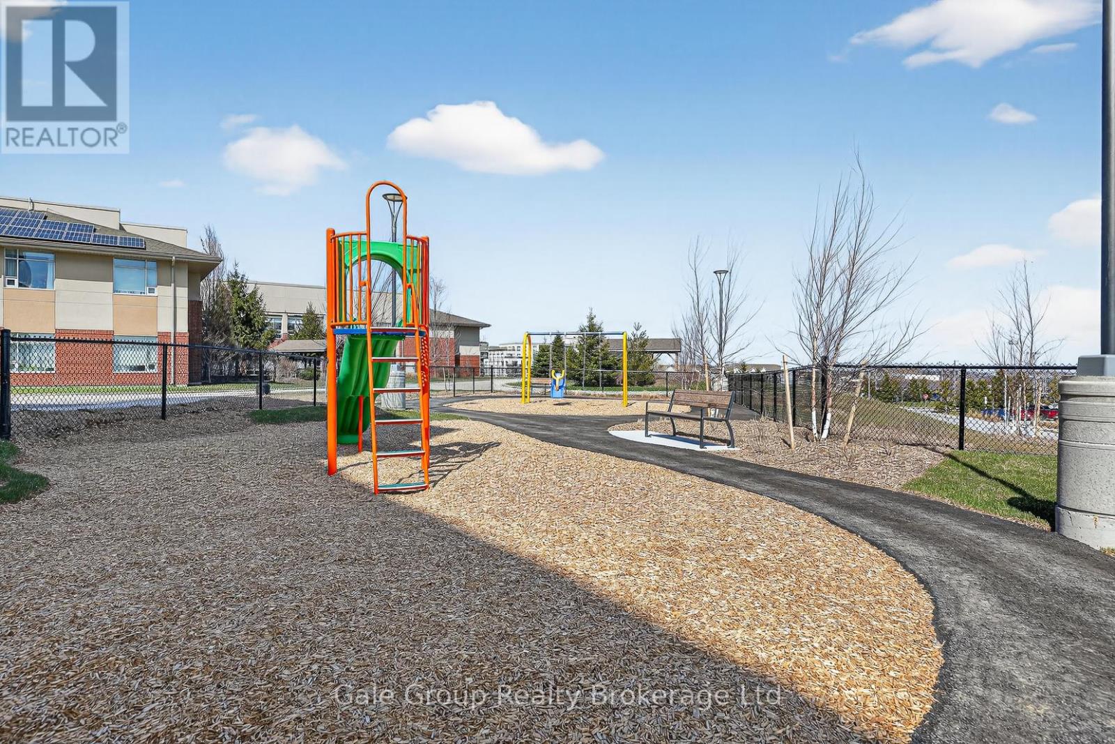 A playground with a slide and a climbing frame.