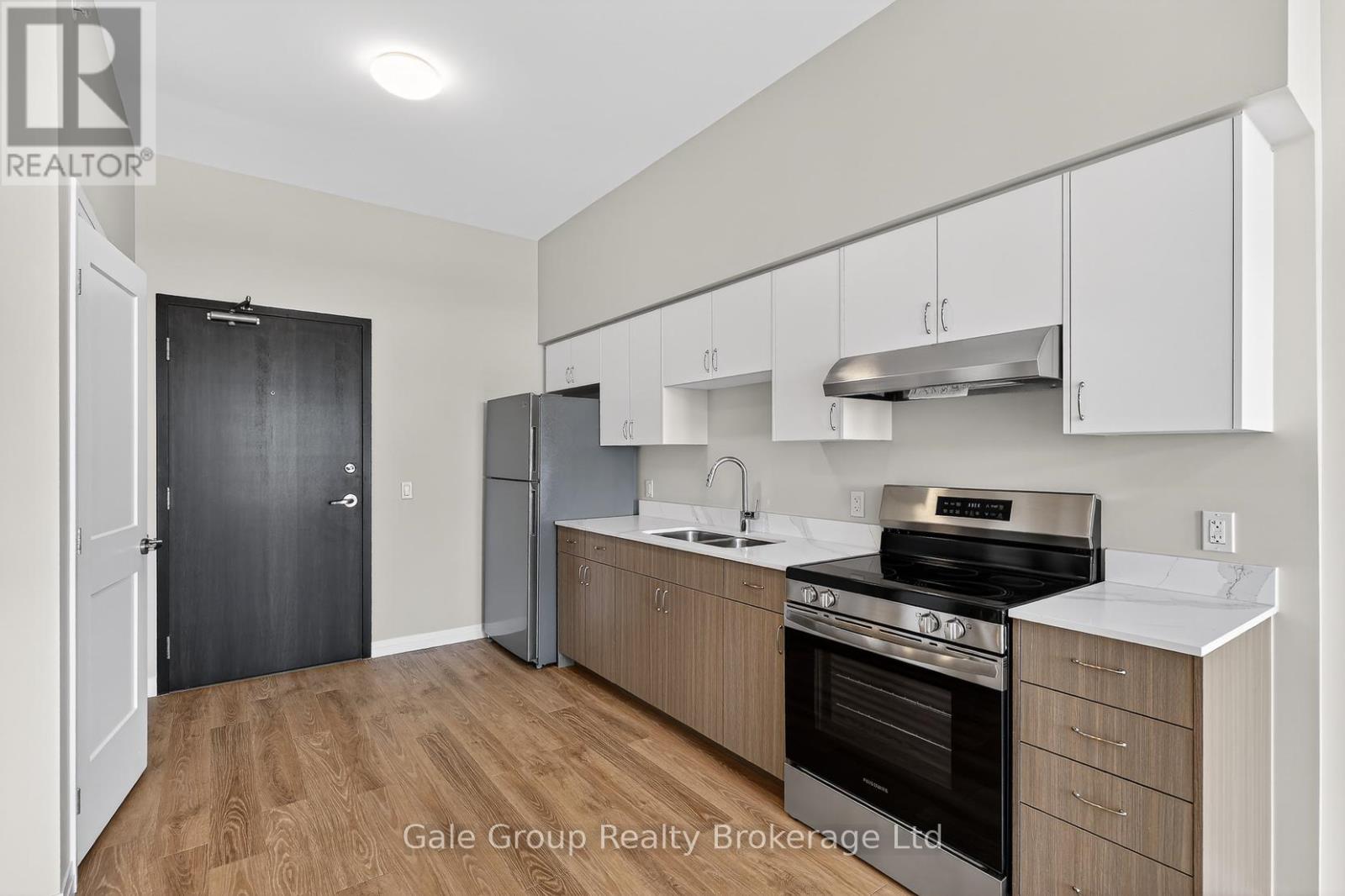 A kitchen with white cabinets and a black oven.