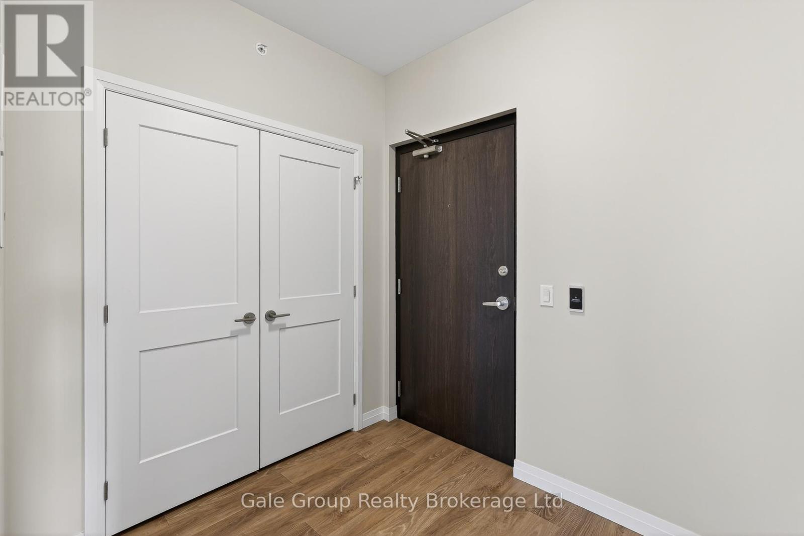 A room with a white door and a brown door.