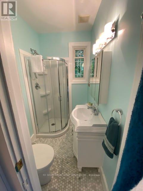 A white sink is in a bathroom with a blue wall.