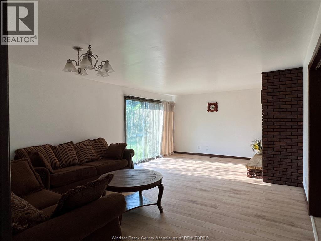 A living room with a brown couch and a round table.