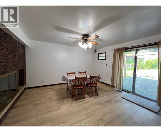 A dining room with a table set for four.