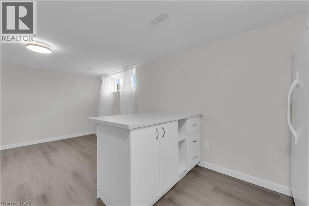 A white kitchen with a counter and drawers.