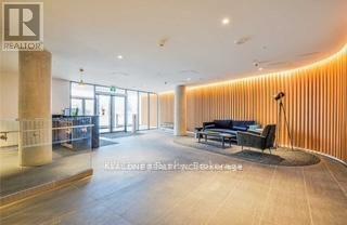 A modern interior space with a reception desk and seating area.