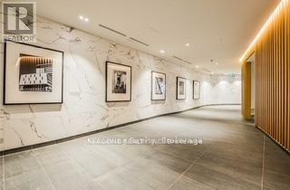 A hallway with a series of framed pictures on the wall.