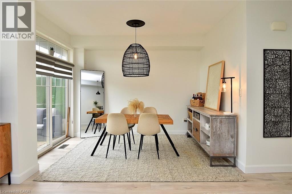 A dining room with a table and chairs.