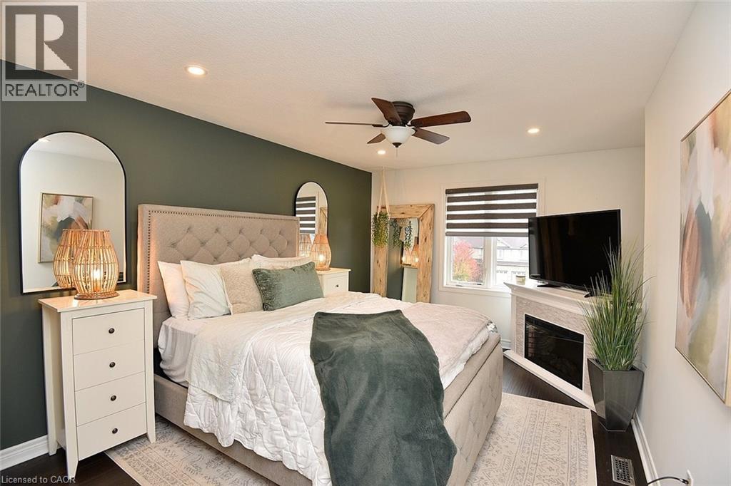 A bedroom with a large bed and a ceiling fan.