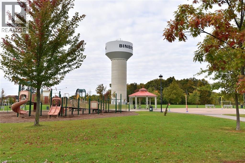 A playground with a water tower in the background.