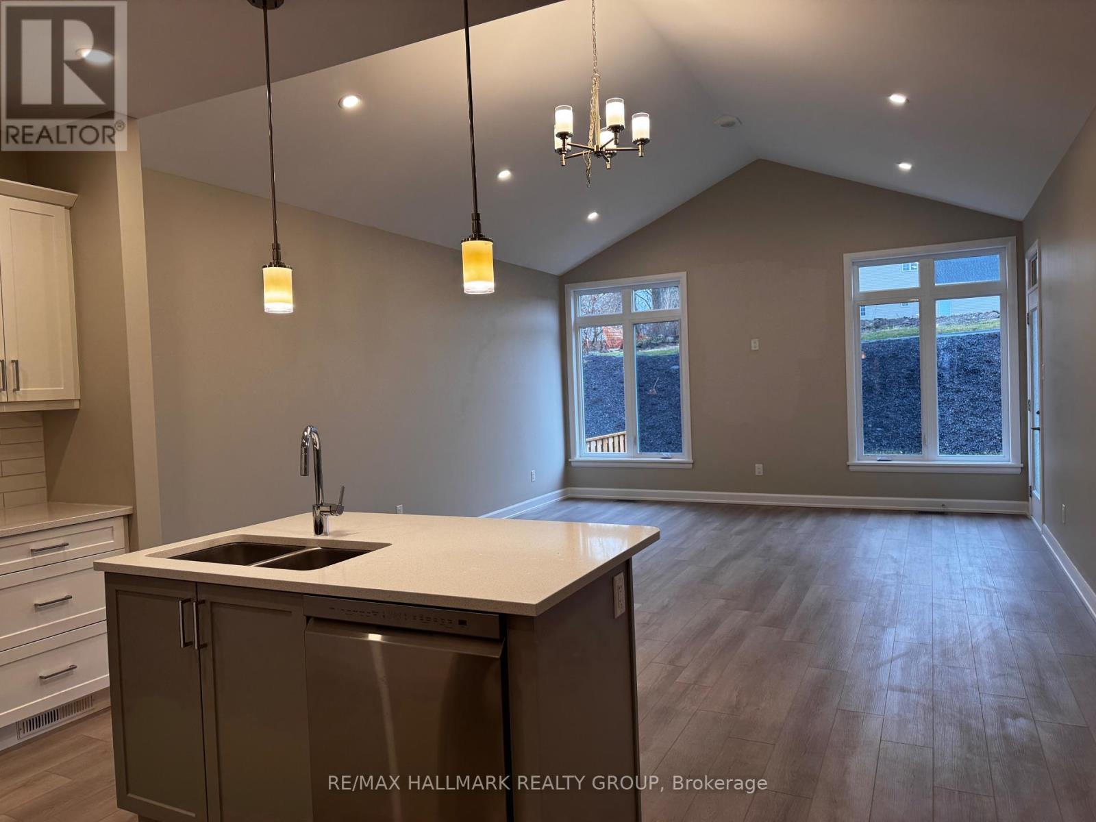 A kitchen with a sink and cabinets is shown in this image.