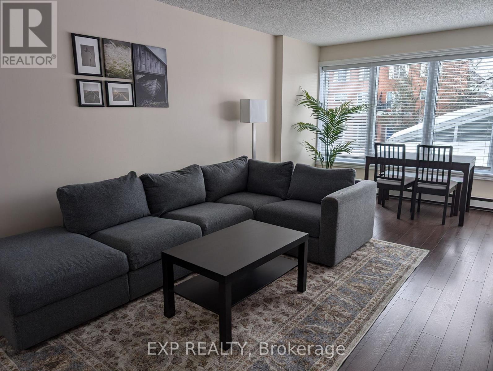 A grey sectional sofa with a coffee table in front of it.