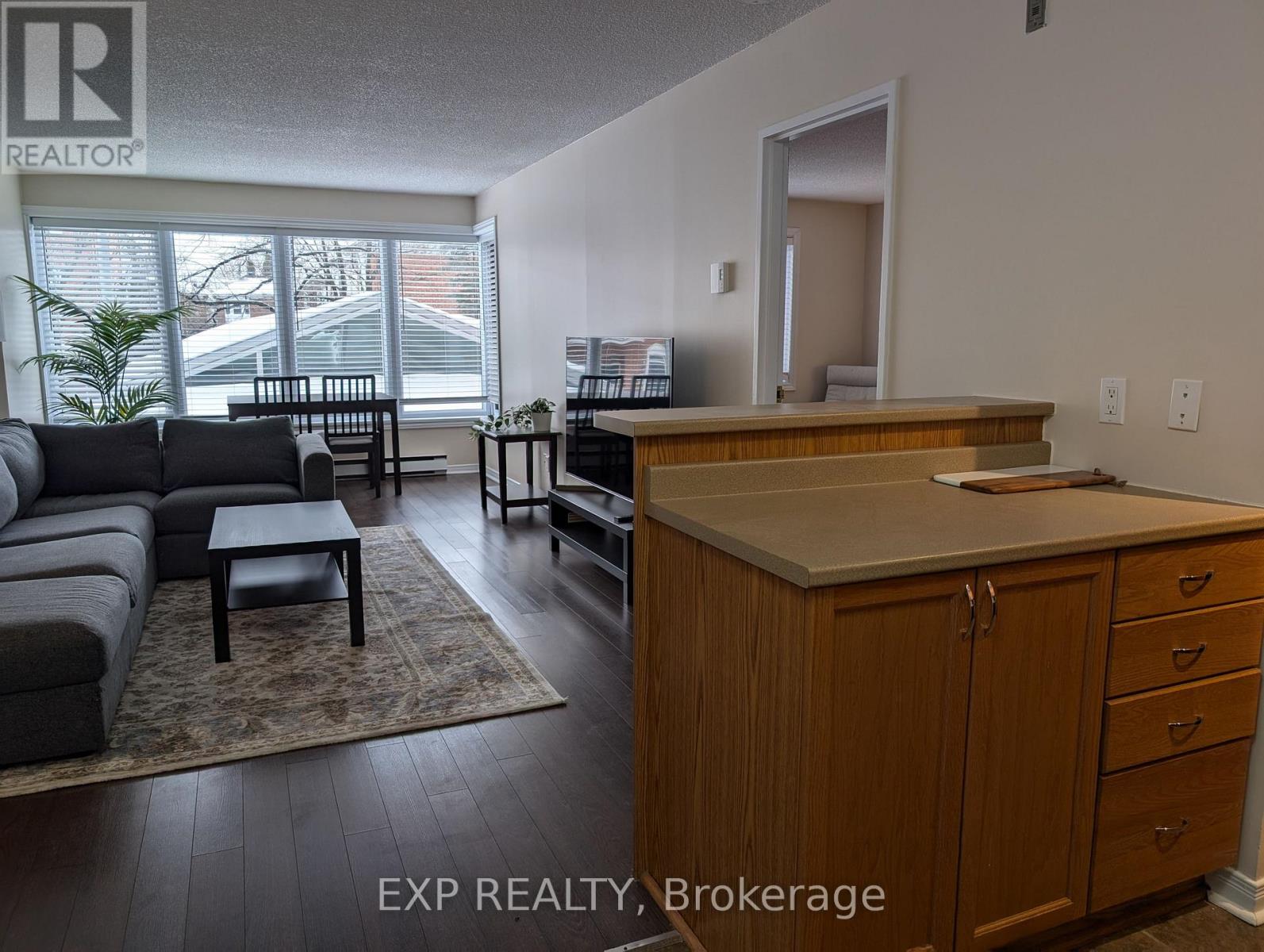 A living room with a couch, a coffee table, and a cabinet.
