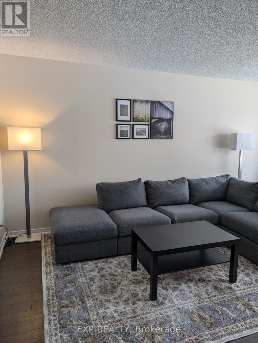 A grey couch with a coffee table in front of it.
