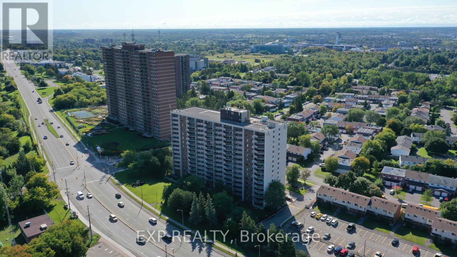 A real estate company logo is superimposed on an aerial view of a cityscape.