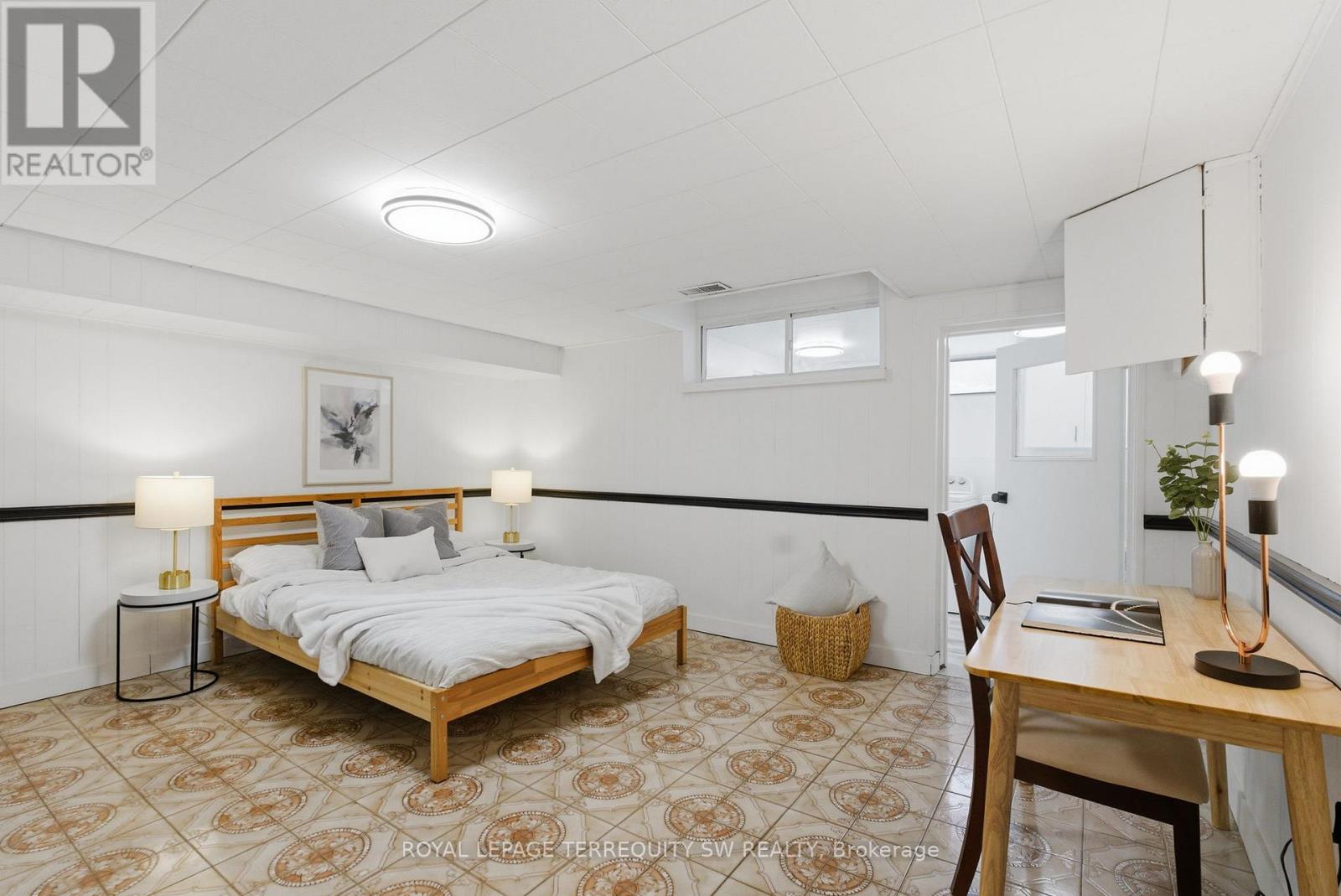 A bedroom with a bed, desk, and chair.