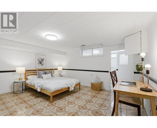 A bedroom with a bed, desk, and chair.