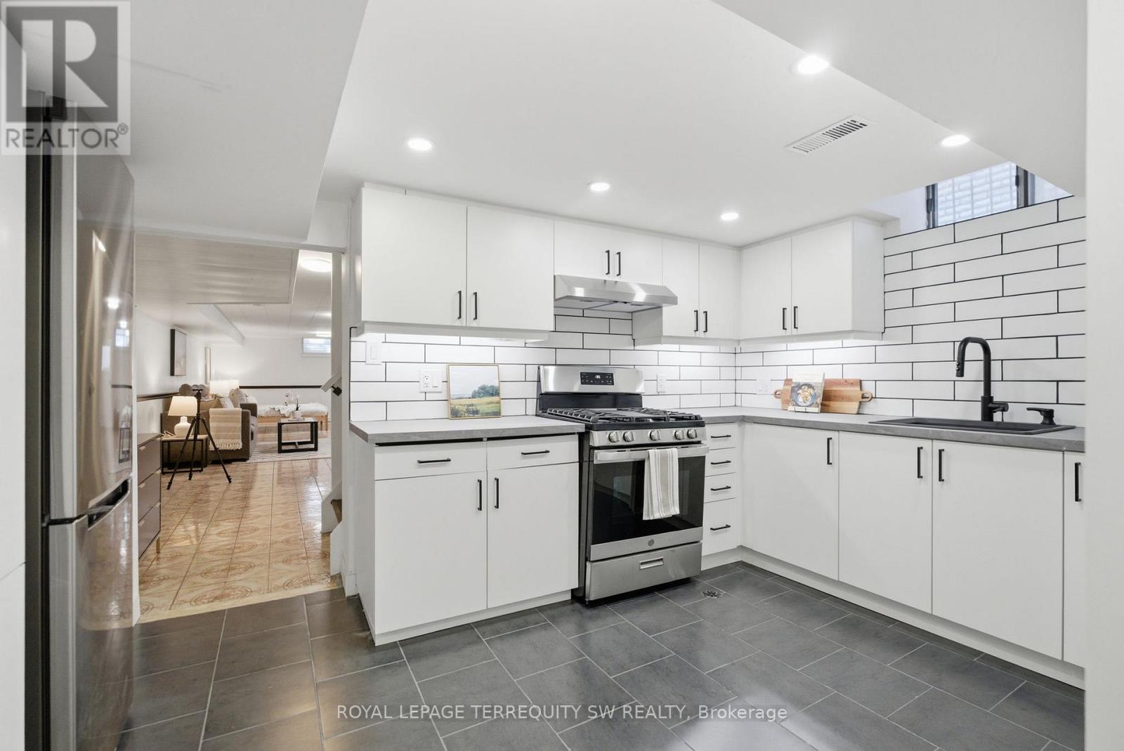 A modern kitchen with white cabinets and a stainless steel oven.
