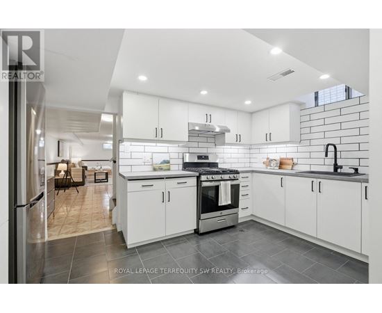 A modern kitchen with white cabinets and a stainless steel oven.