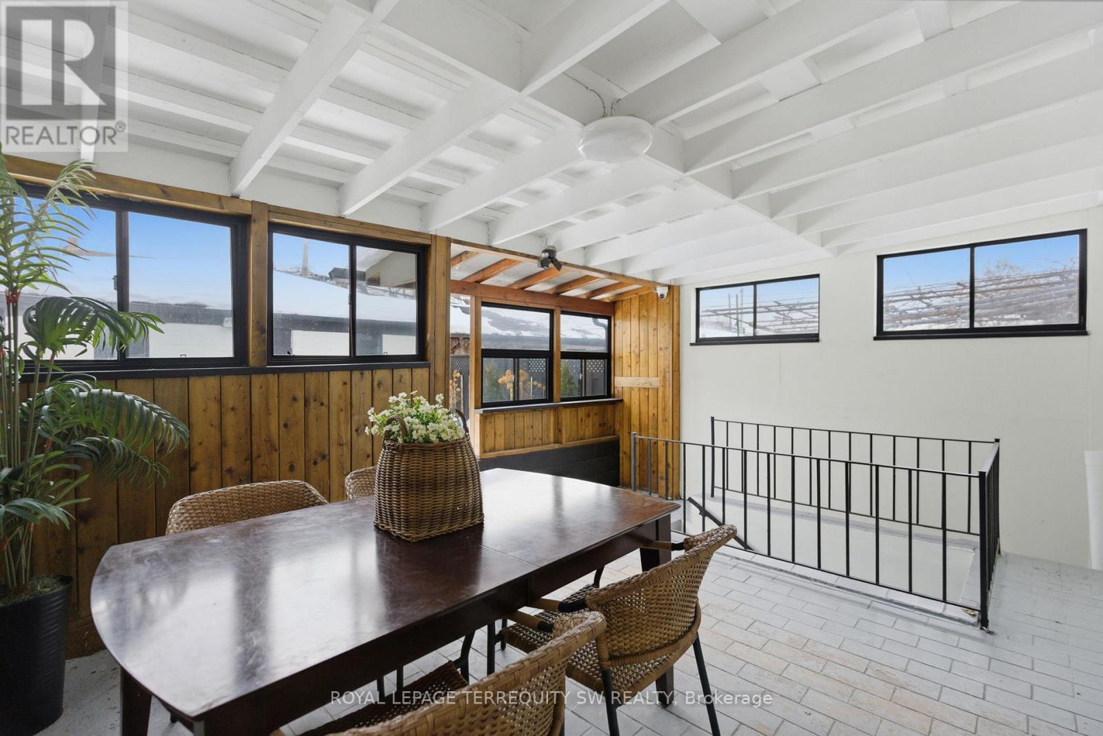 A dining room with a wooden table and chairs.