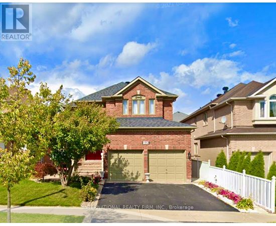 A house with a garage and a driveway is for sale.