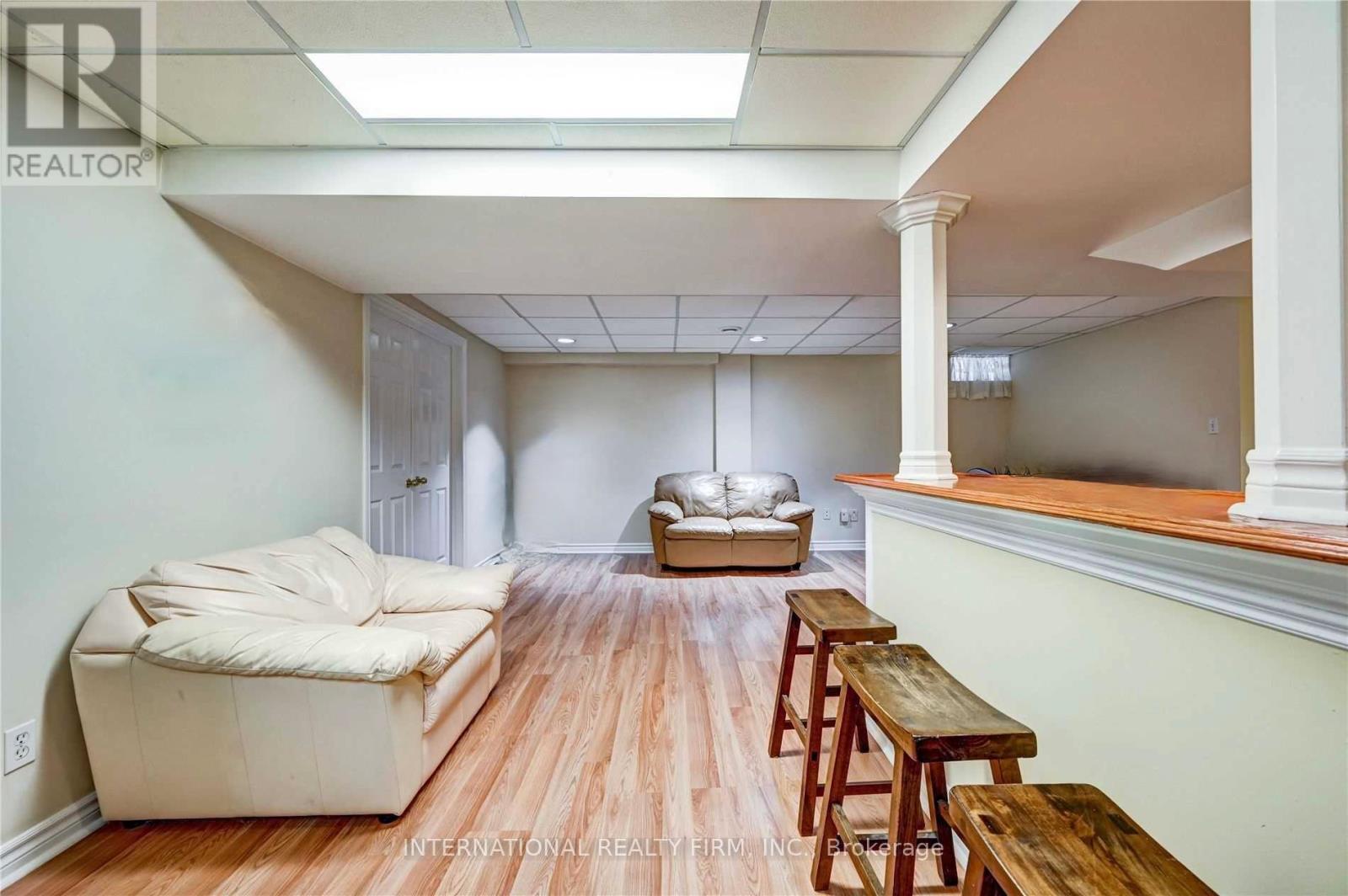 A living room with a couch, a table, and a window.