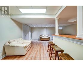 A living room with a couch, a table, and a window.