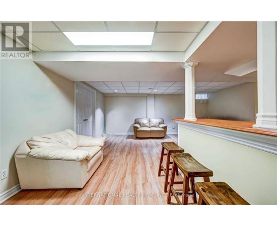 A living room with a couch, a table, and a window.