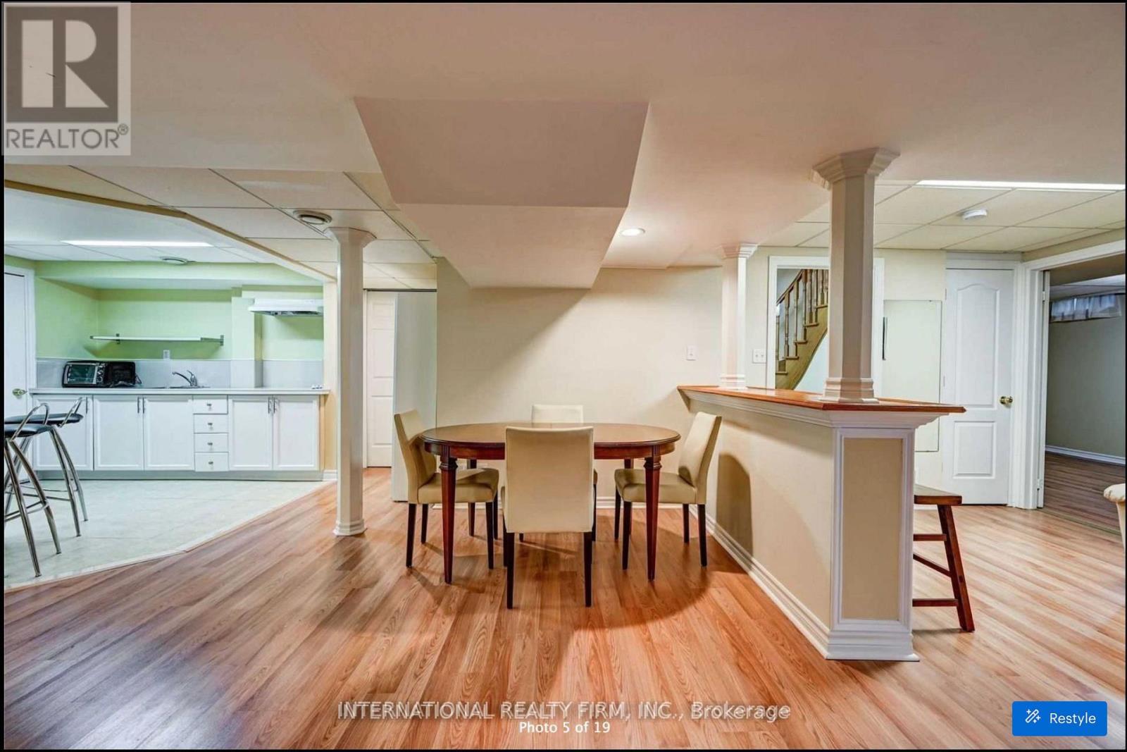 A dining room with a table and chairs.