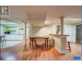 A dining room with a table and chairs.