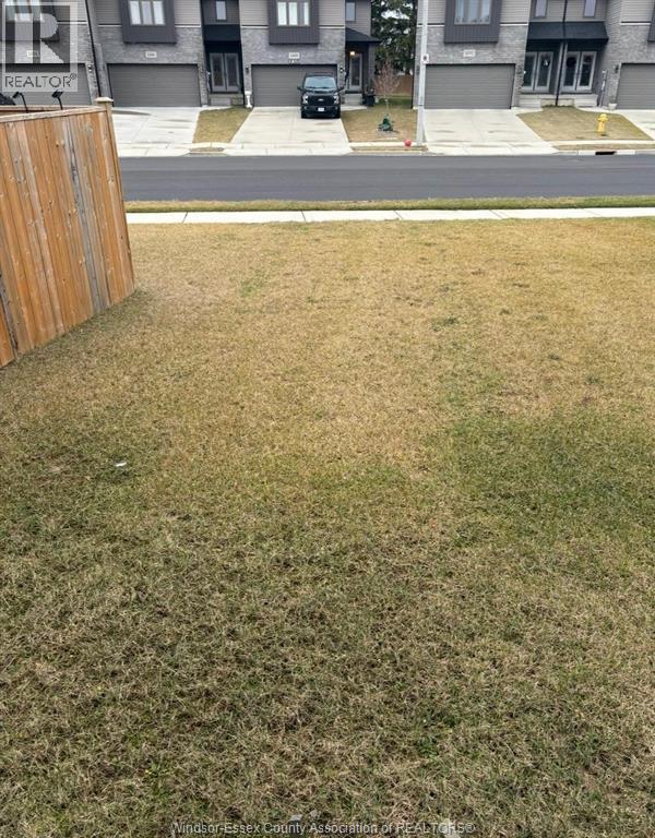 A grassy area in front of a building with a sign that says "REALTOR".