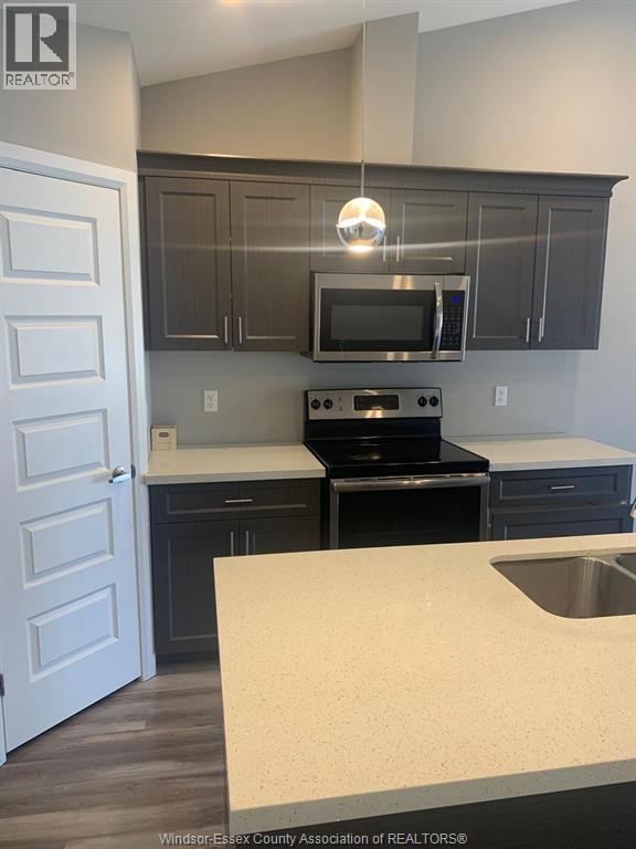 A kitchen with a stove top oven and microwave.