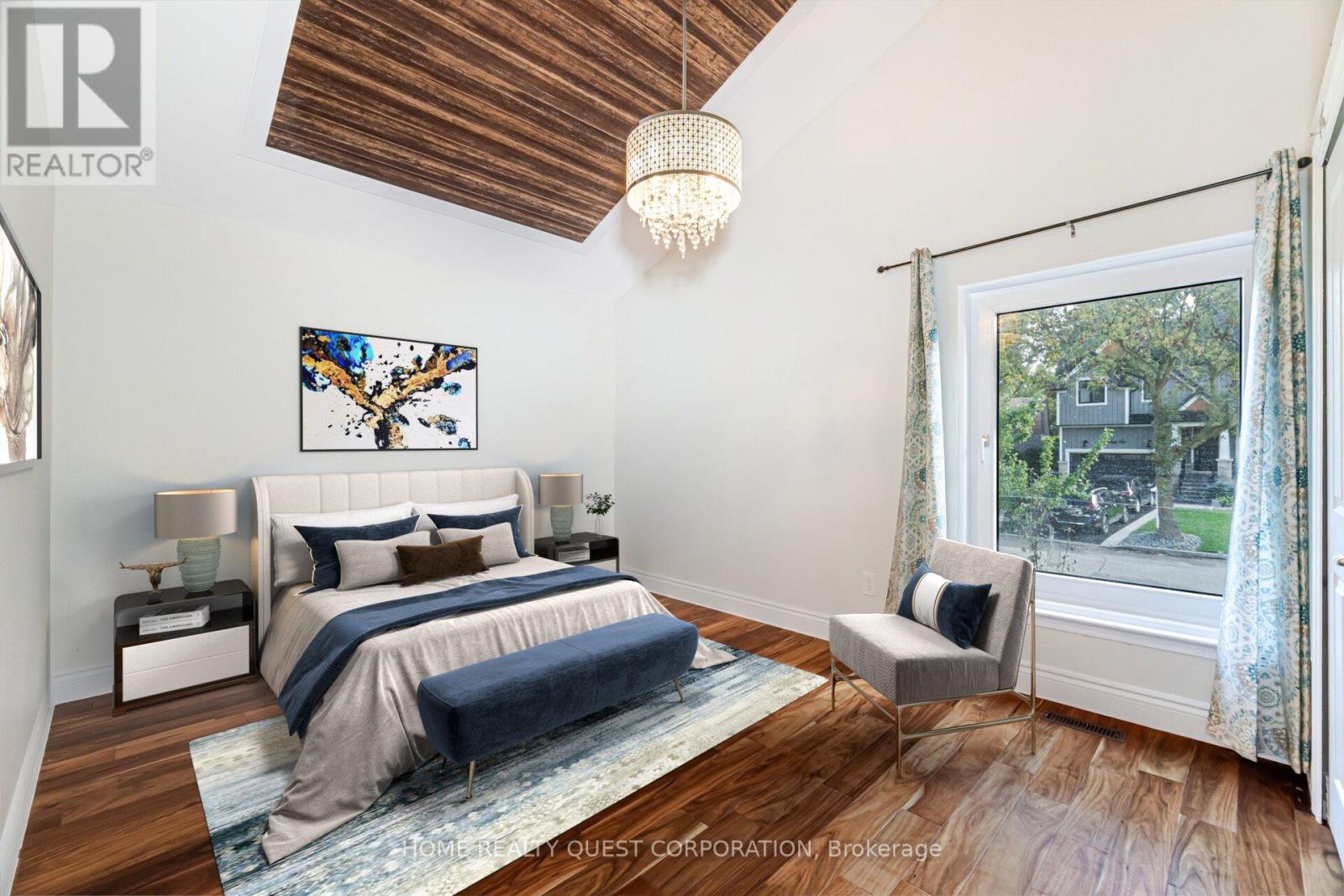 A bedroom with a bed, a chair, and a painting on the wall.