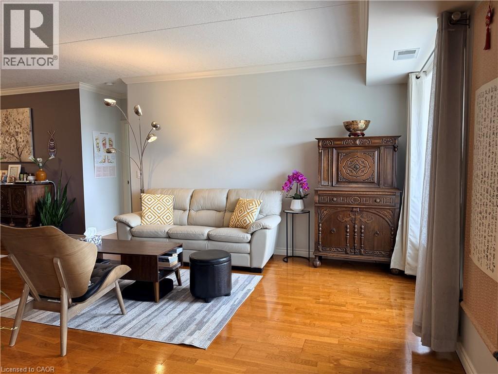 A living room with a brown chair and a white couch.