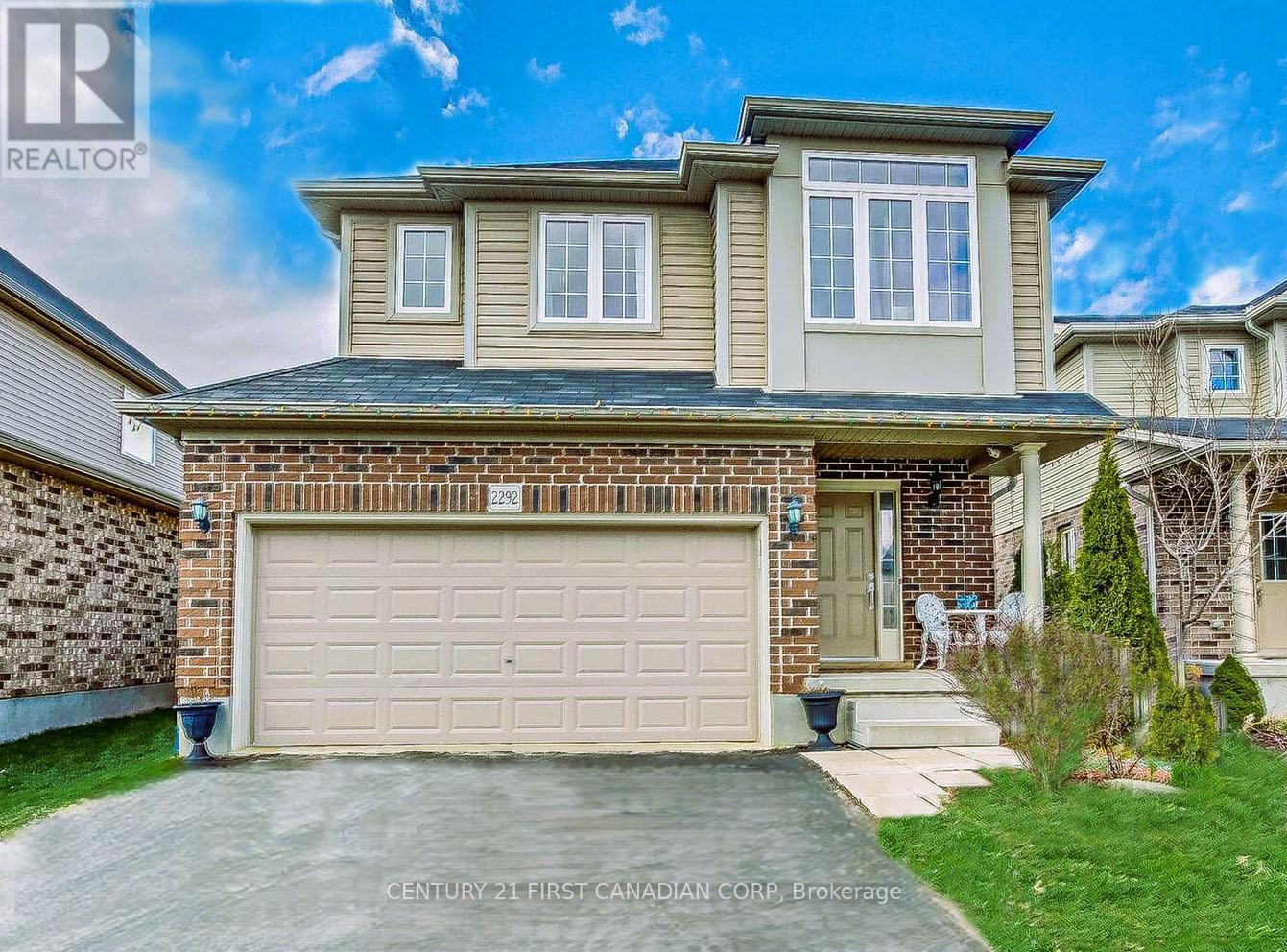 A house with a garage is for sale by Century 21 First Canadian Corp.