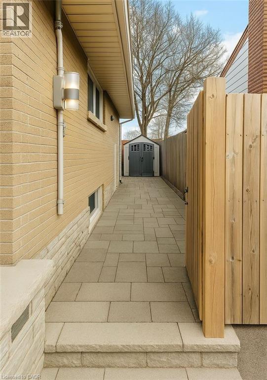 A wooden fence leads to a garage.