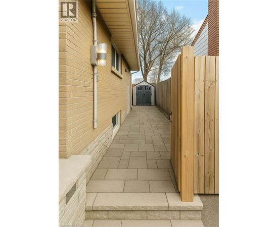 A wooden fence leads to a garage.