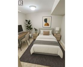 A bedroom with a bed, desk, and chair.
