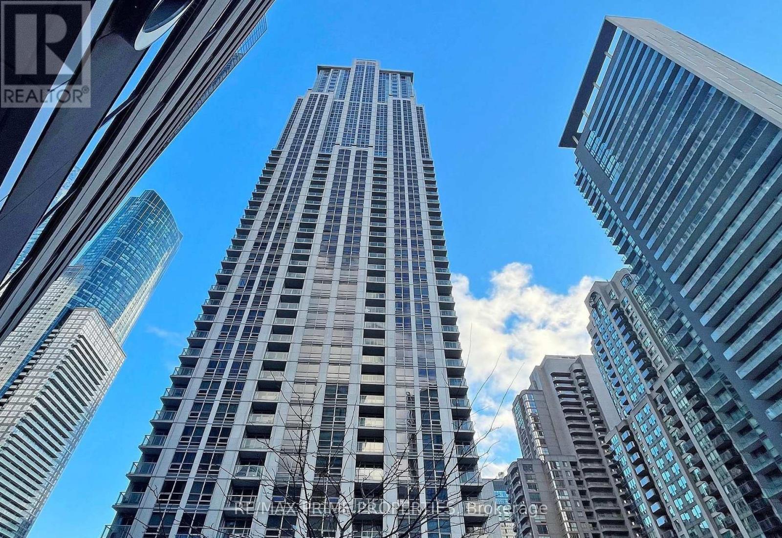 A tall building stands in the middle of a cityscape.