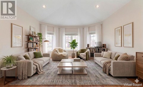 A virtual staged living room with a grey sofa set, a coffee table, and a bookshelf.