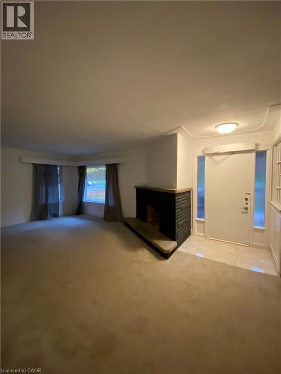 A spacious living room with a fireplace and sliding glass doors.