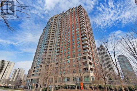 A tall residential building with many windows and balconies.