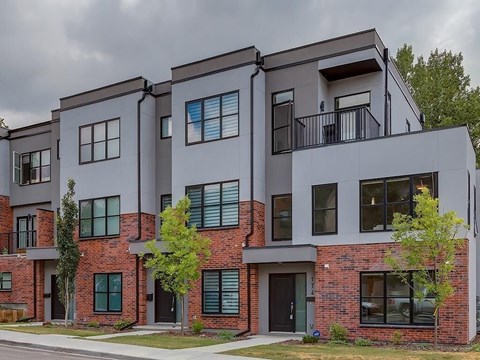 A modern two story building with balconies and windows.