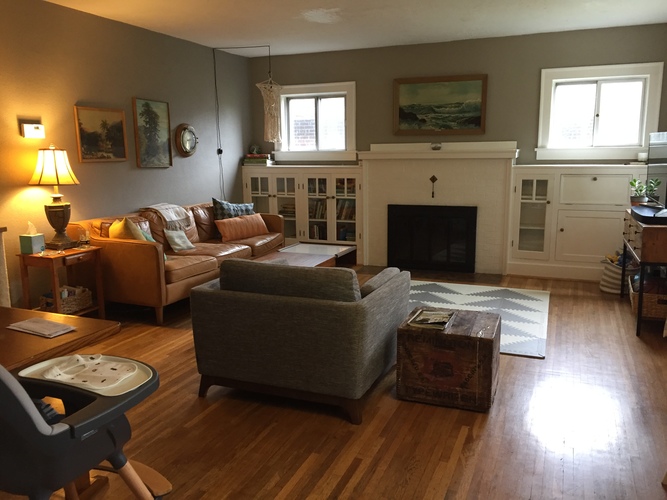 A living room with a fireplace and a couch.