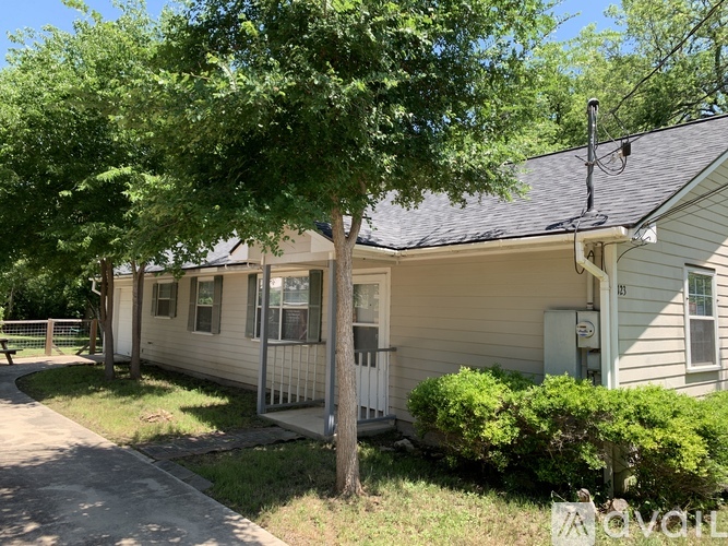 A house with a tree in front of it.