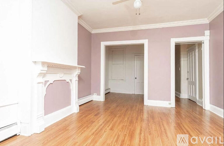 A room with a fireplace and wooden floors.