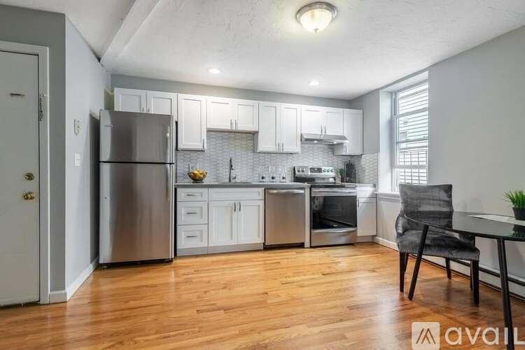 A kitchen with wooden floors and stainless steel appliances.