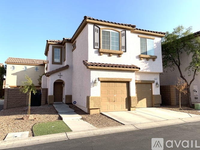A two-story house with a garage is available for sale.