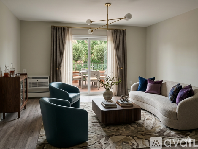 A living room with a sofa, armchairs, and a coffee table.