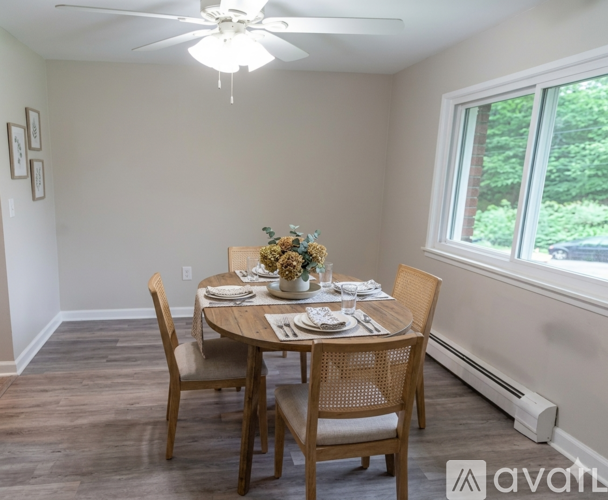 A dining room with a table set for four.